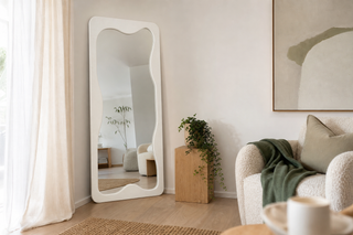Cheval curvy full length mirror with a wavy off white frame leaning in a bright NZ living room — curvy mirror NZ
