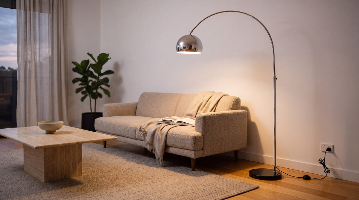 The chrome floor lamp: high shine, and the marble base doing the quiet work