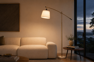 Floor lamp bulb temperature NZ — brass arc floor lamp casting a warm 2700K glow over a cream linen sofa in a Kiwi lounge at dusk