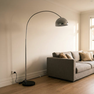 Floor lamp cable management NZ — chrome and white marble base floor lamp with cord routed neatly along the skirting board to a wall power point in a Kiwi living room