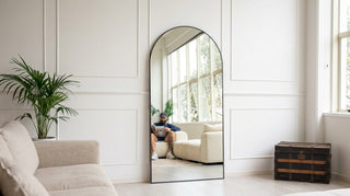 Large floor mirror NZ — 200cm arched black freestanding mirror leaning in a double height Auckland living room