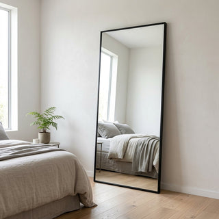 Mirror types NZ — slim matte black rectangular Zenith X full-length mirror leaning in a bright minimal New Zealand bedroom