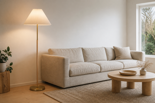 Scandinavian floor lamp NZ — Luma pleated shade with brushed brass base and wide pleated pagoda shade beside a natural linen sofa in a minimalist Kiwi living room
