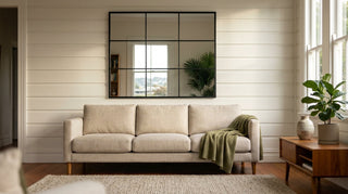 Large statement wall mirror above a linen sofa in a modern New Zealand lounge