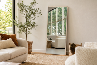 Wood vs metal frame mirror NZ — pale wood-look Branewood full-length mirror leaning in a warm, light-filled Kiwi living room
