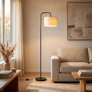 Fabric and linen floor lamps by C&F Creation: the Marceau linen drum lamp glowing beside a sofa
