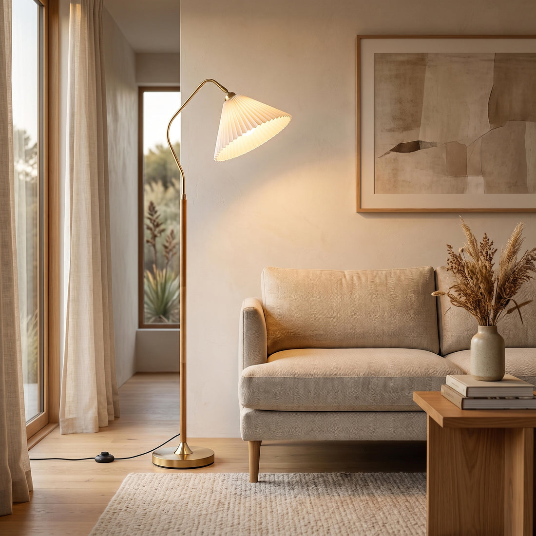Aurelia Pleated Fabric Floor Lamp glowing warm beside a sofa in a New Zealand living room at night