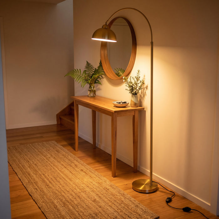 Orsay Gold Arc Floor Lamp brightening a stylish entryway beside a console table