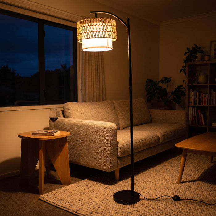 Rousseau Rattan Weave Floor Lamp glowing warm at night with the evening lights turned low