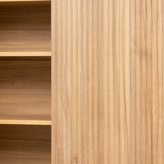 Close-up of the Renne shoe cabinet showing the vertical fluted door design beside open internal shelving, highlighting the oak wood finish and modern craftsmanship.