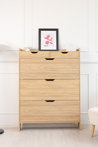 Risa Slim Shoe Cabinet in oak finish, slim and tall storage solution styled in a bright modern room with framed artwork and soft furnishings.